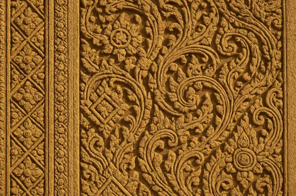 Bas-relief with apsaras in Angkor Wat — close-up of sandstone carving