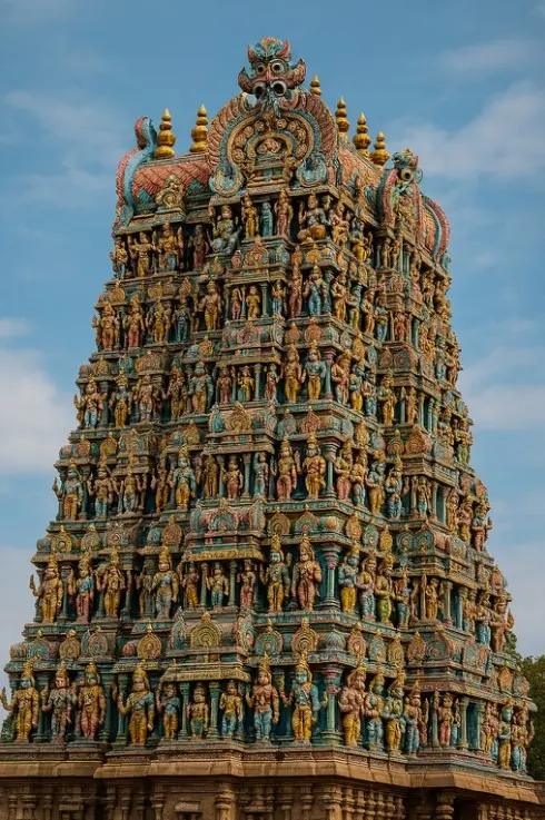 Colorful gopuram of the Meenakshi Temple, decorated with numerous statues
