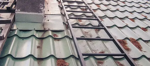 Corrosion at metal roofing damage points