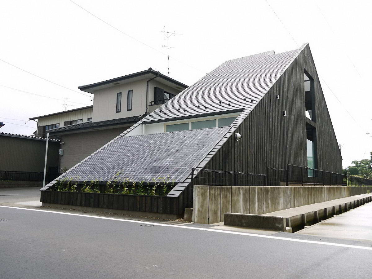 Eco-facade: modern Japanese house with integrated solar panels and wooden cladding